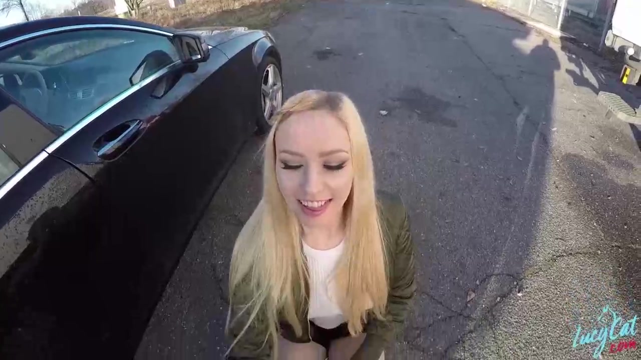 Hot blonde darling is kneeling and sucking a horny stranger’s big dick, in a public place