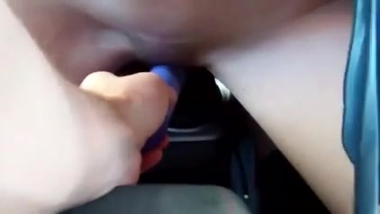Busty babe has some alone time fun in the car, burring her pussy and riding the gearshift