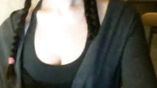 Long haired German brunette with huge black glasses is fingering her pussy in front of the camera