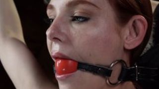 Gagged redhead tormented in hogtie