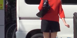 High heeled asian ho pees on road