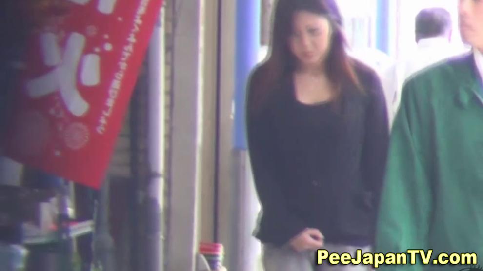 Asian pisses down alley