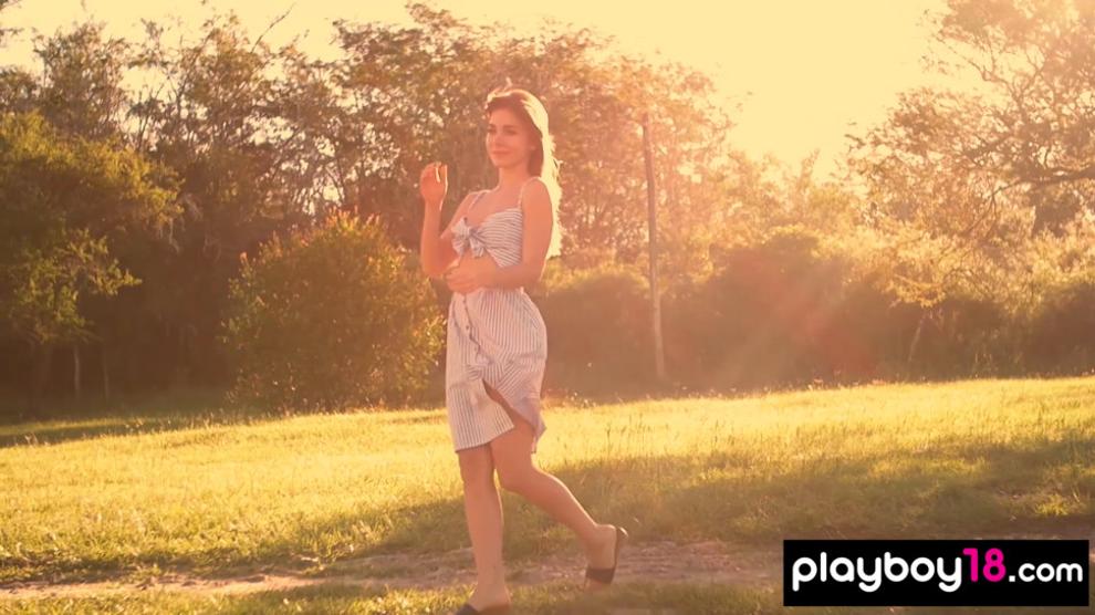 All natural teen Lillii stripping slowly on a meadow
