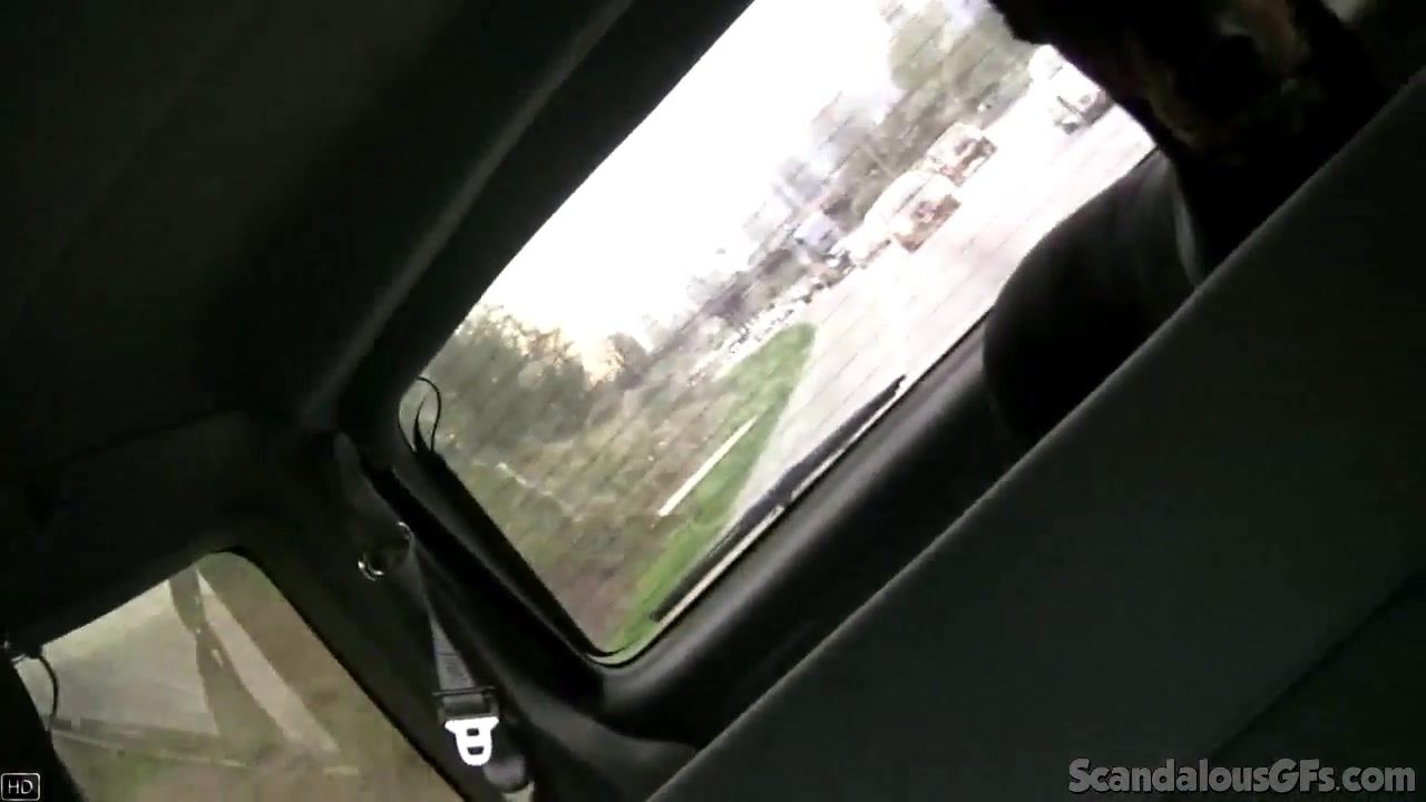SCANDALOUSGFS - Hot Babe rubbing a cock while the guy driving caught on tape