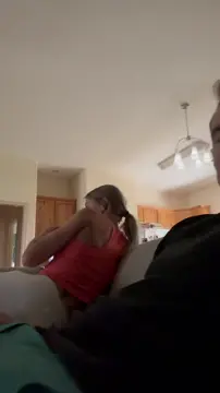 Giving my husband a blowjob on the couch in a red tank top